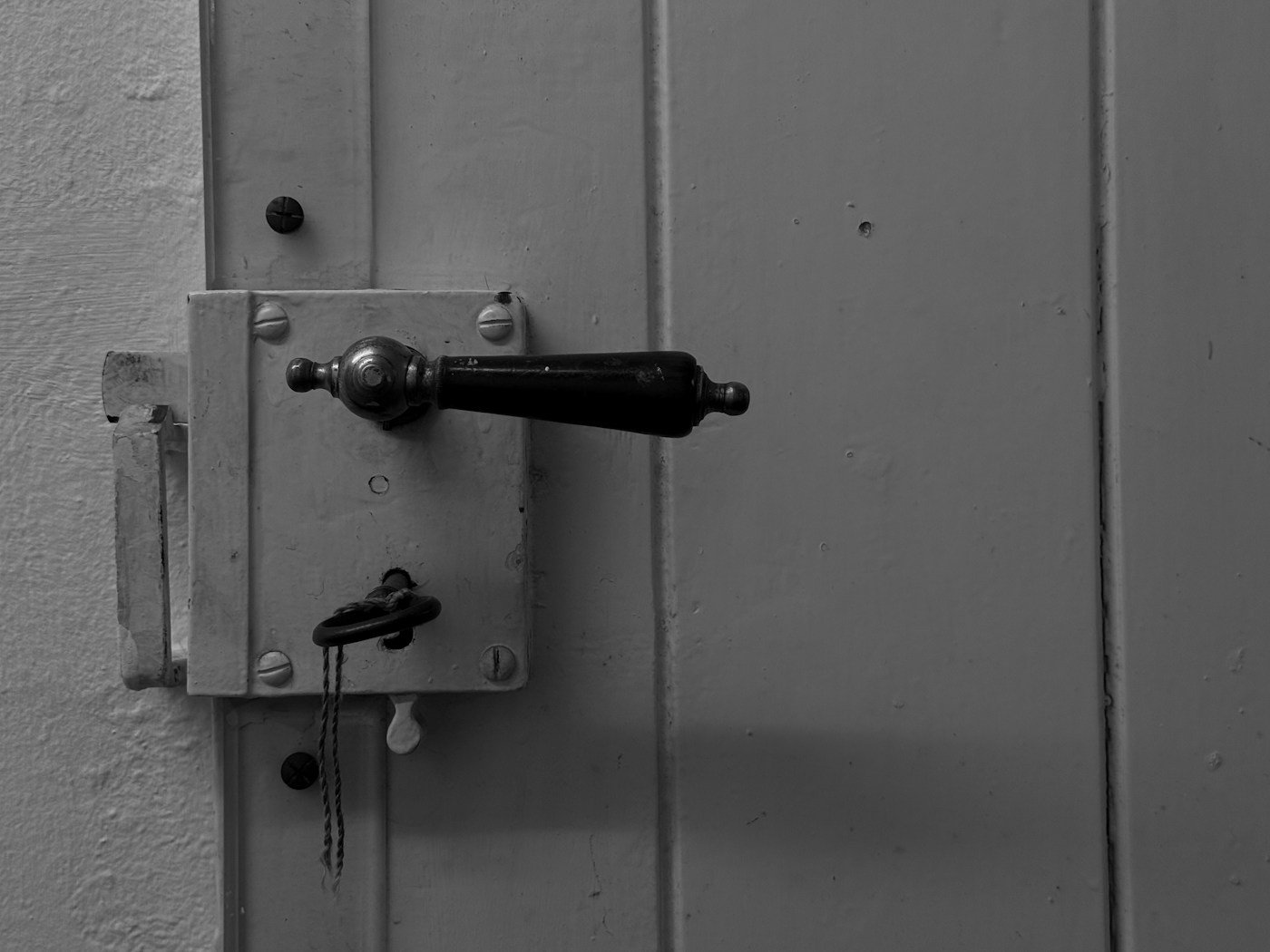 Close-up of a door handle and lock with key inserted